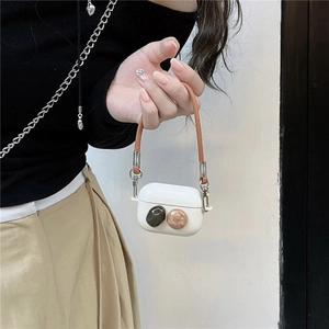 Elegant white silicone AirPods Pro case with gemstone accents and a leather strap