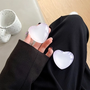 Close-up of translucent purple gradient heart phone grip held by a person