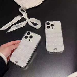 Clear iPhone case featuring 3D glitter bowknots and pearl accents on a sleek surface