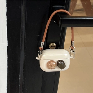 Premium white silicone AirPods Pro case with decorative gemstones and brown leather hand strap