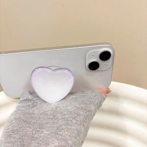 Detailed view of a purple gradient heart phone grip mounted on a white smartphone
