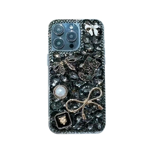 Luxury iPhone case featuring black rhinestones, white bow, pearls, and metallic number 5