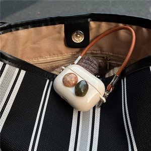 Elegant silicone AirPods Pro case with decorative gemstones and leather hand strap