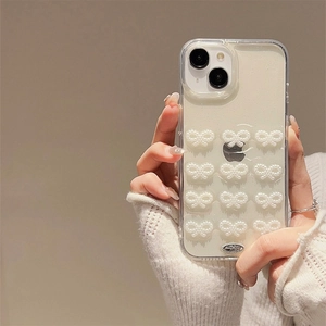 Glittery iPhone case with white 3D pearl bows on a creamy white pearlescent background
