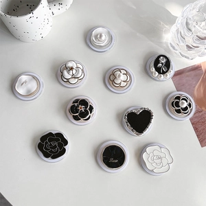 Magnetic metal floral phone sockets set with camellia and heart designs in black and gold