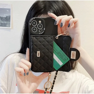 Detail of black quilted leather phone case with gold lock wallet and chain strap