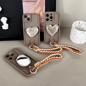 Brown silicone phone cases with mirror heart detail and braided crossbody strap