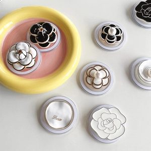 Detailed view of camellia flower phone grips with pearls and Love letter accents