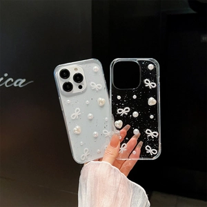 Chic iPhone case with white pearls, 3D hearts, and ribbon bow on silver foil background