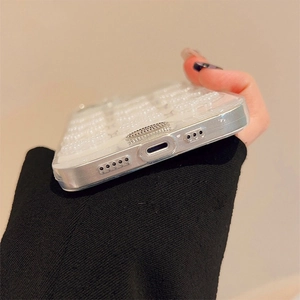 Detail of precise cutouts for charger and speakers on pearl texture iPhone case