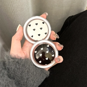 Detail of heart pattern phone grip holders in black and white glossy finish