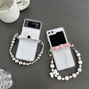Clear Samsung Z Flip 6 case with silver bow and pearl beaded chain strap accessories