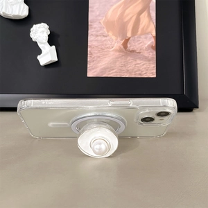 Macro shot of magnetic pearl phone socket on transparent iPhone 14 case with chic aesthetic