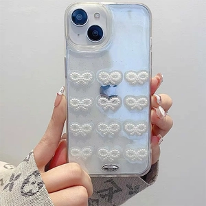 Detail of transparent iPhone case with pearl 3D bows and oval lovels metal plate