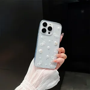 Detailed shot of grey-blue iPhone case featuring silver foil, pearls and bow-knot accent