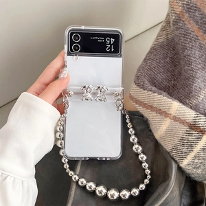 Detail of clear Z Flip 6 case with silver metallic bead chain and double bear charms