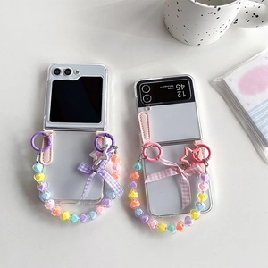 Transparent Samsung Galaxy Z Flip 6 case with heart bead chain and plaid bow