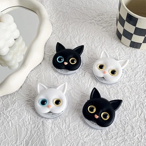 Detail of odd-eyed cat phone grips in black and white matte silicone finish