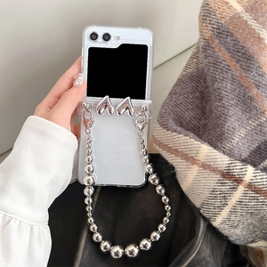 Detail of transparent Galaxy Z Flip 6 case with silver heart charms and beaded chain