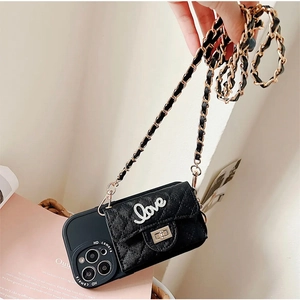 Detail of black quilted leather iPhone case with gold Love lock and chain strap