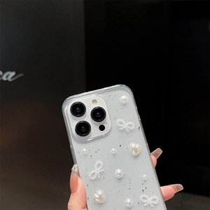 Detail of iPhone case with silver glitter, pearls, and a bow held by a person