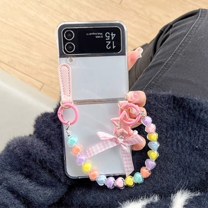 Detail of transparent Galaxy Z Flip 6 case with pink bow and colorful heart bead strap