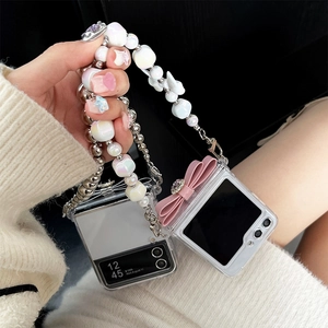 Detail of clear Galaxy Z Flip case with pink silk bow and heart pearl beaded handle