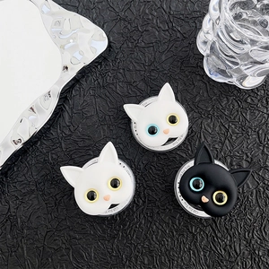 Three cat-shaped magnetic phone grips on dark textured background with Gift For You base