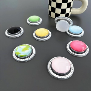 Detail of round magnetic phone sockets with colorful glass finish and transparent base