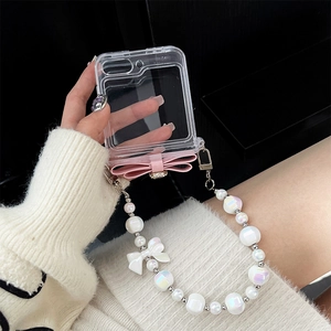 Close-up of Galaxy Z Flip case with pink bow and long pearl bead lanyard strap