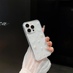 Detail of transparent iPhone case with silver foil, white pearls and 3D ribbon bows