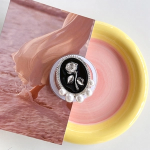 Detail of magnetic phone grip featuring vintage silver rose relief and white pearls