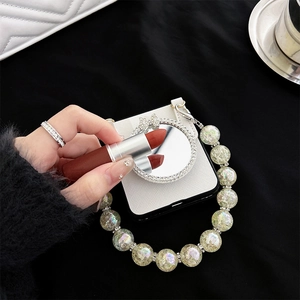 Close-up of white leather Z Flip case with diamond-encrusted mirror and pearl chain