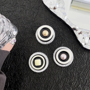 Macro detail of luxury pearl phone socket stand with Gift For You lettering on leather
