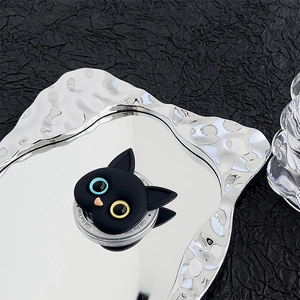 Macro detail of 3D black cat phone socket with heterochromatic blue and yellow eyes