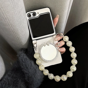 Detail of cream Z Flip case with mirror stand and decorative bead wrist strap