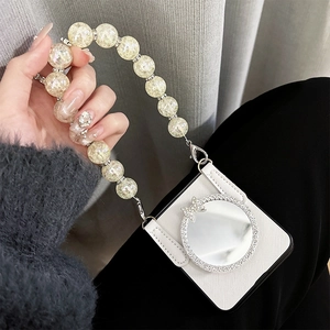 Detail of white cross-grain leather phone case with rhinestone mirror and beaded handle