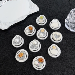 Magnetic heart pearl cell phone grip stand collection on a minimalist black backdrop