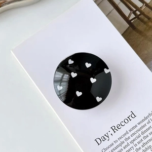 Close-up of black phone socket with white heart pattern on a display card
