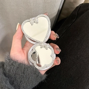 Detail view of heart-shaped magnetic phone mirror with rhinestones and bow accent