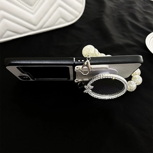 Detail of Galaxy Z Flip phone case with diamond butterfly mirror and pearl chain