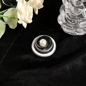 Macro shot of MagSafe phone grip with black and white resin swirl and central pearl detail