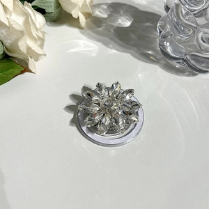 Macro view of crystal flower MagSafe phone grip with sparkling rhinestone inlay