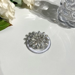 Detailed view of rhinestone flower MagSafe grip with silver base and crystal petals