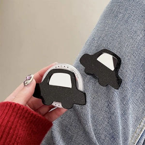 Close-up of glitter car phone grip tok on blue jeans showing compact portable design