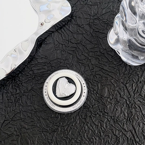 Detail of magnetic MagSafe heart phone socket with Gift For You print on black tray