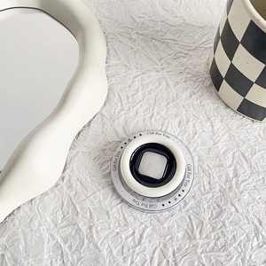Detail showing a circular acrylic phone grip with 'Gift For You' text and stars design