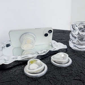 Close-up of pearl heart phone grip showing 3D crystal inlay and 'Gift For You' ring