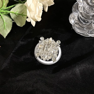 Macro detail of luxury crystal phone holder with sparkling rhinestones and flower design