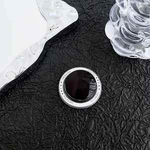 Macro shot of circular magnetic phone socket with Gift For You print on textured background